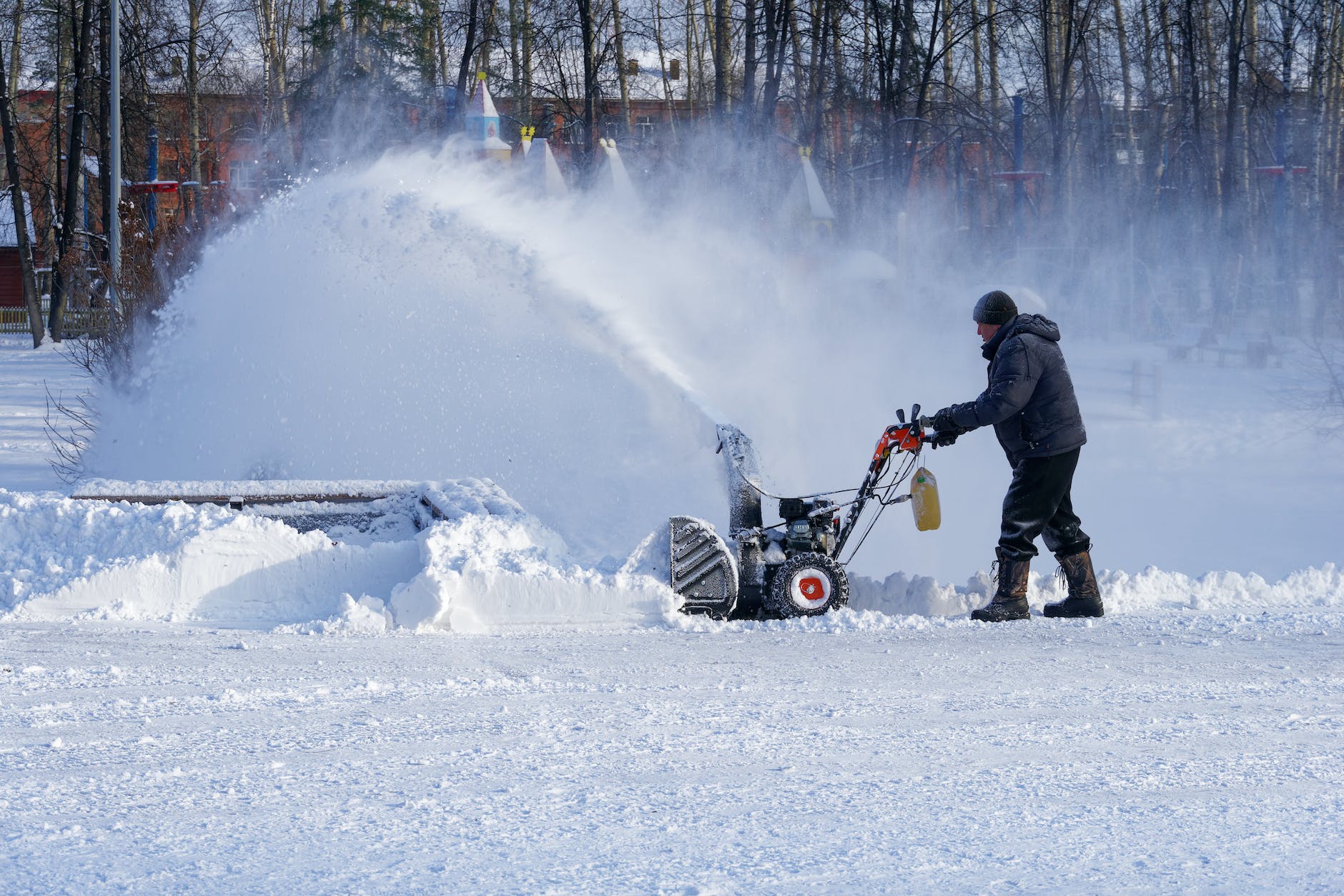 man removing snow with snow blower